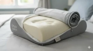 A close-up photorealistic view of a contoured memory foam pillow with the cover unzipped to show the high-density core designed for bespoke lower back support.