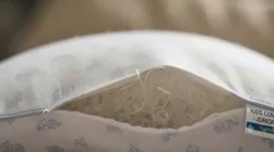 Close-up of breathable, hypoallergenic fabric used in high-quality junior pillows.