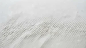 Close-up of breathable, hypoallergenic cotton fabric on a toddler pillow cover.