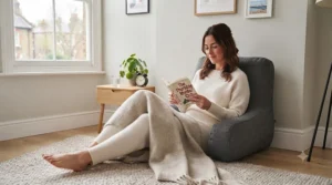 A plush bed rest pillow used on a living room rug for casual floor lounging during movie night.