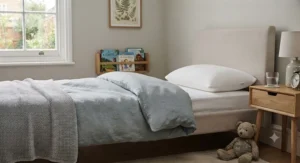A styled, cosy child's bed featuring a clean, white hypoallergenic pillow.