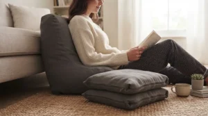 Backrest pillow for bed utilised on a living room rug for casual lounging, laptop use, or watching television.