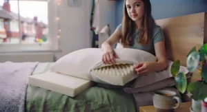 A teenager removing a washable pillow cover to demonstrate easy home maintenance and hygiene.