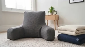 A range of neutral-coloured husband pillows in cream, navy, and charcoal styled on a modern divan bed.