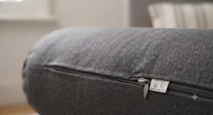 Close-up of a breathable, washable cotton cover on a quality bolster pillow for support.