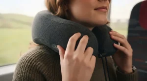 Demonstrating the correct way to position a travel neck pillow for optimum cervical alignment.