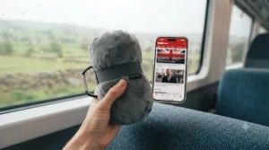 Lightweight travel pillow held in hand, demonstrating its compact size for airline hand luggage.