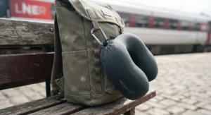 A compact travel pillow clipped securely to the exterior of a weekend rucksack for easy transit.