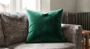 Vibrant accent square cushion bringing a pop of colour to a neutral modern sofa.
