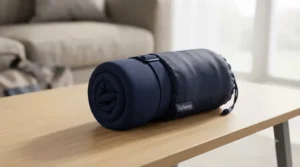 Compact travel pillow for side sleepers compressed inside a waterproof storage bag.