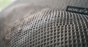 Detailed view of the breathable 3D mesh fabric covering a back support massager.