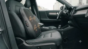 Portable massage pillow for a car seat plugged into a 12V socket inside a vehicle interior.