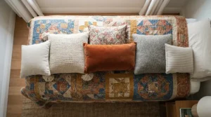 King size pillows laid out alongside smaller cushions to show the generous width difference